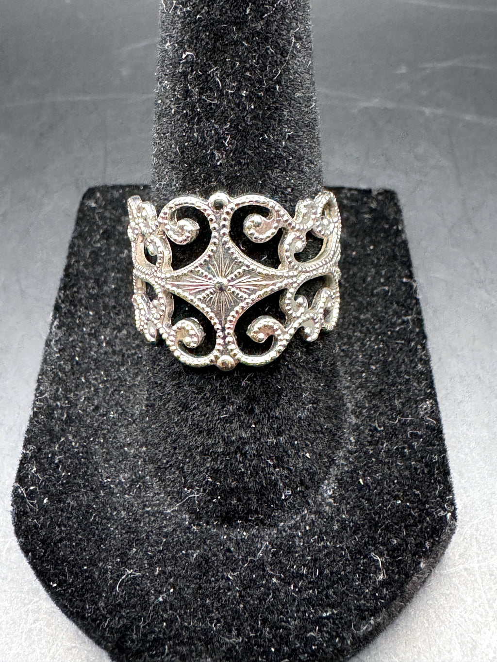 Unbranded silver-tone adjustable ring with ornate scrollwork front view