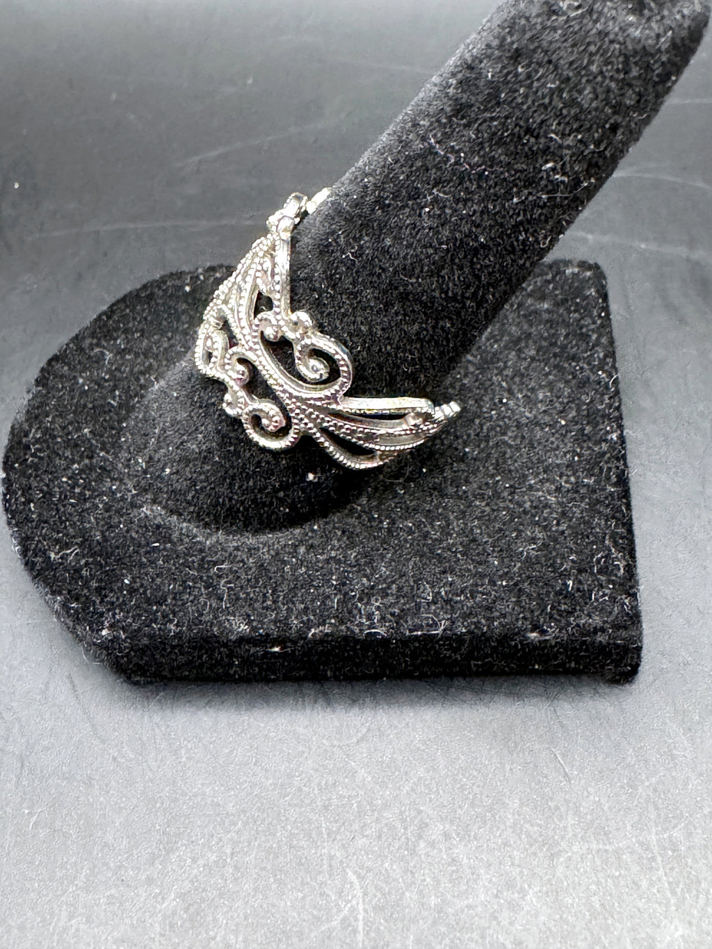 Unbranded silver-tone adjustable ring side view showing ornate scrollwork