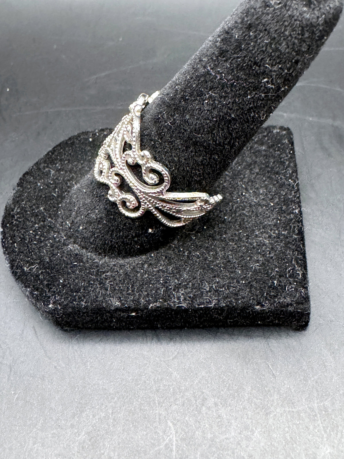 Unbranded silver-tone adjustable ring side view showing ornate scrollwork